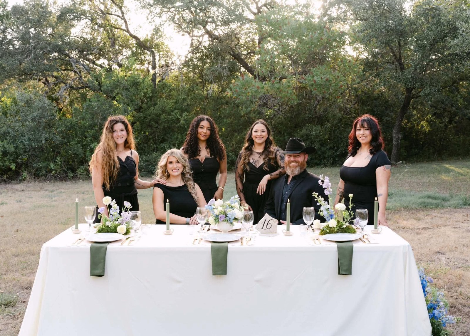 The Savvy Southern Events team gathered behind a wildflower-set reception table in the Texas Hill Country